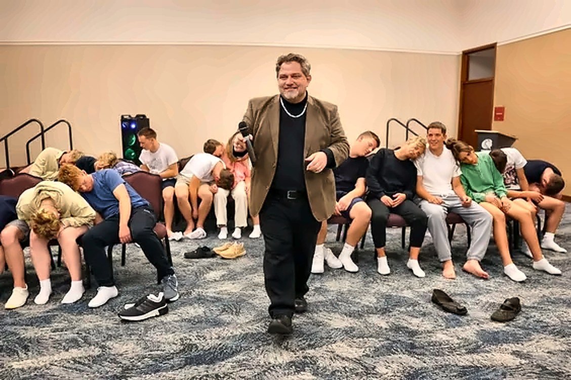 Clean comedy hypnotist Michael Oddo on stage with volunteers during an interactive hypnosis show